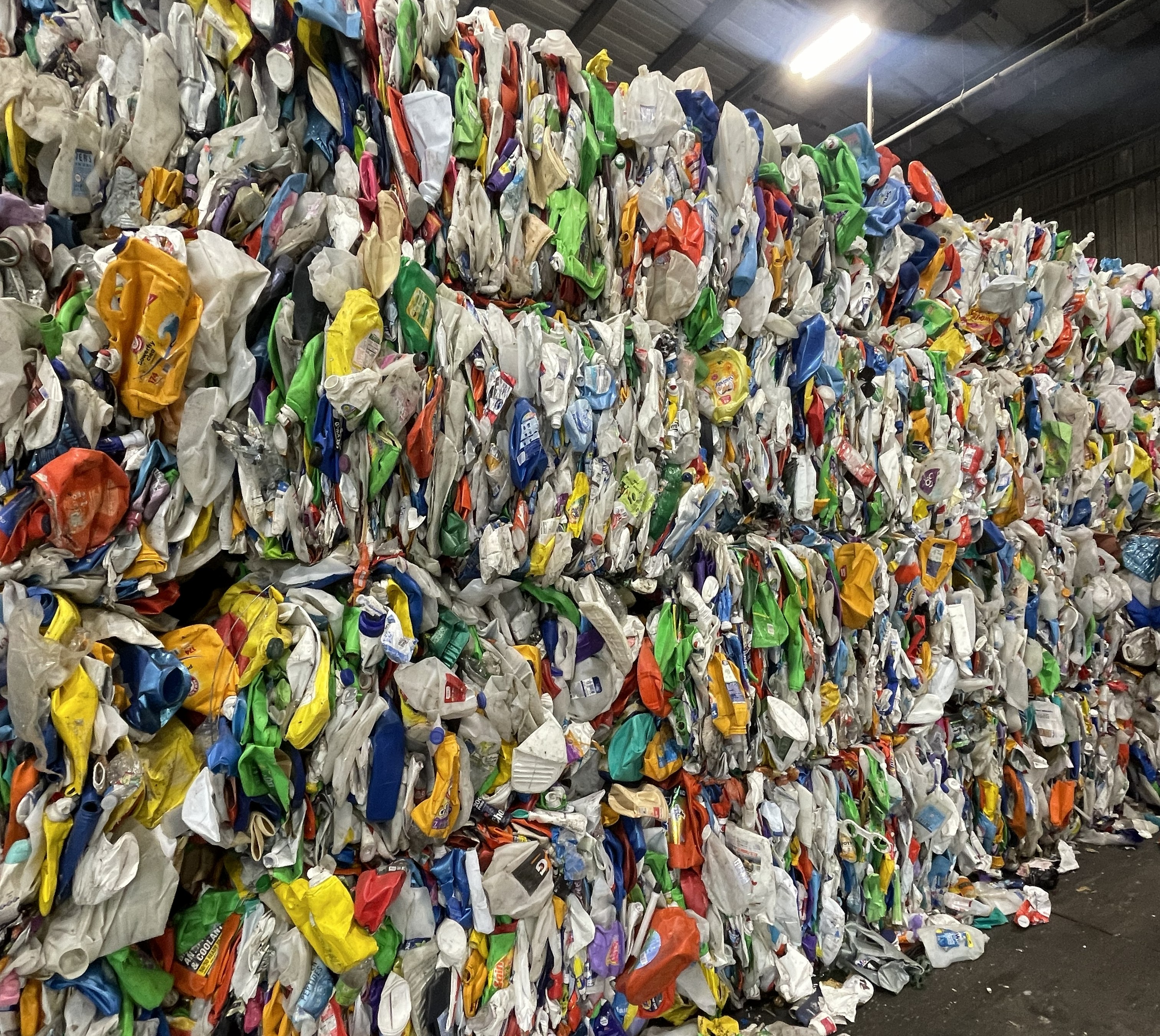 Color HDPE blow molding bales stored in warehouse, recycled post-consumer mixed color plastic