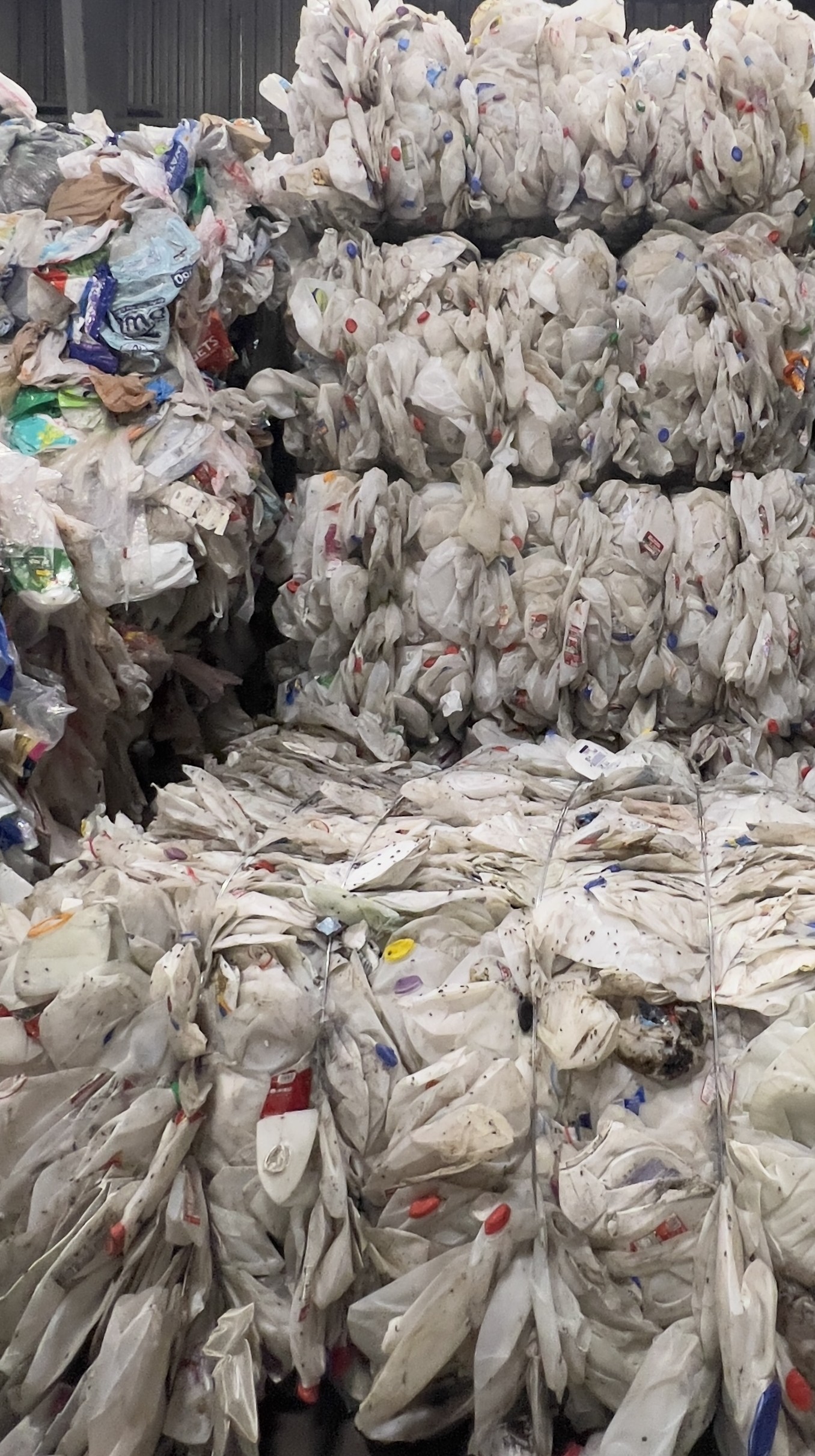 Natural HDPE milk jug bales stored in warehouse, ready for export and bottle-to-bottle recycling