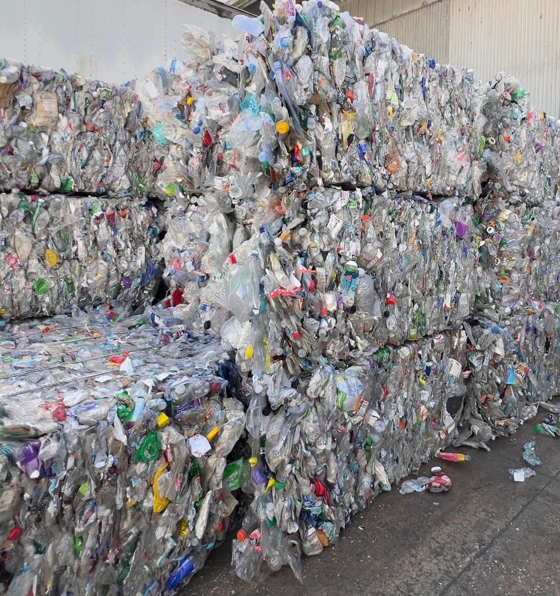 Side view of post-consumer PET bales, recycled plastic bottles compacted for fiber and bottle-to-bottle recycling
