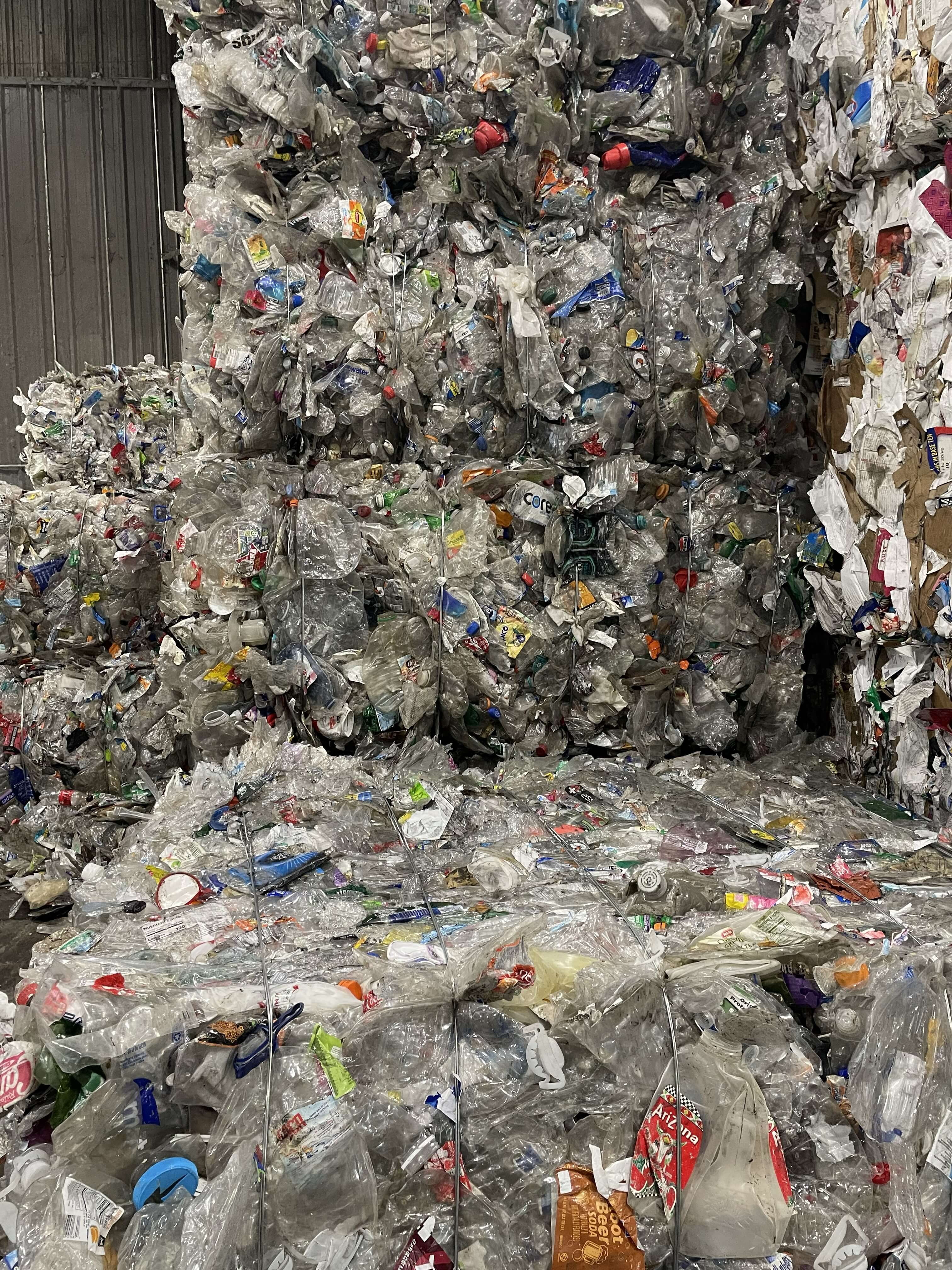 Post-consumer PET bales stored in warehouse, ready for international export and bottle-to-bottle recycling